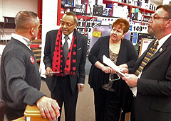 APWU members Venus Abaoag-Smith and Roy Gernhardt look on as Local President LeRoy Moyer discusses the issue with Assistant Manager Mindy Press.