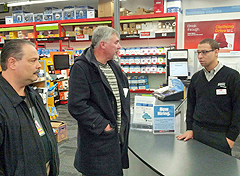 Pittsburgh Metro Area Local Secretary-Treasurer Bob Montana (left ) President Chuck Pugar greet a Staples manager in Pittsburg.