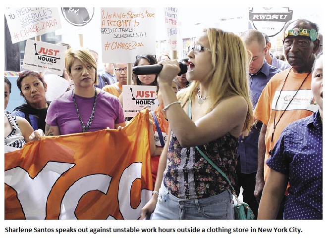 Sharlene Santos speaks out against unstable work hours outside a clothing store in New York City.