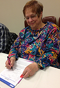 Larry Mathews and Judy Popp sign up to join the Kansas City Golden Jazz Retiree Chapter.