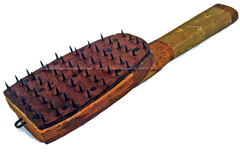 Resembling a hairbrush, this paddle fitted with sharp metal tines instead of bristles was used to prepare mail for fumigation in response to an 1897 Yellow Fever outbreak in Montgomery, AL.