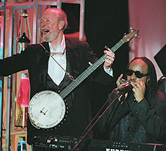 Joined by Stevie Wonder, Seeger performs during his induction into the Rock and Roll Hall of Fame in 1996. He won a Grammy the following year.