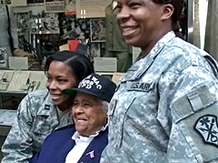 6888th veteran Gladys Schuster Carter poses for a photo with soldiers at a ceremony honoring her unit in 2009.