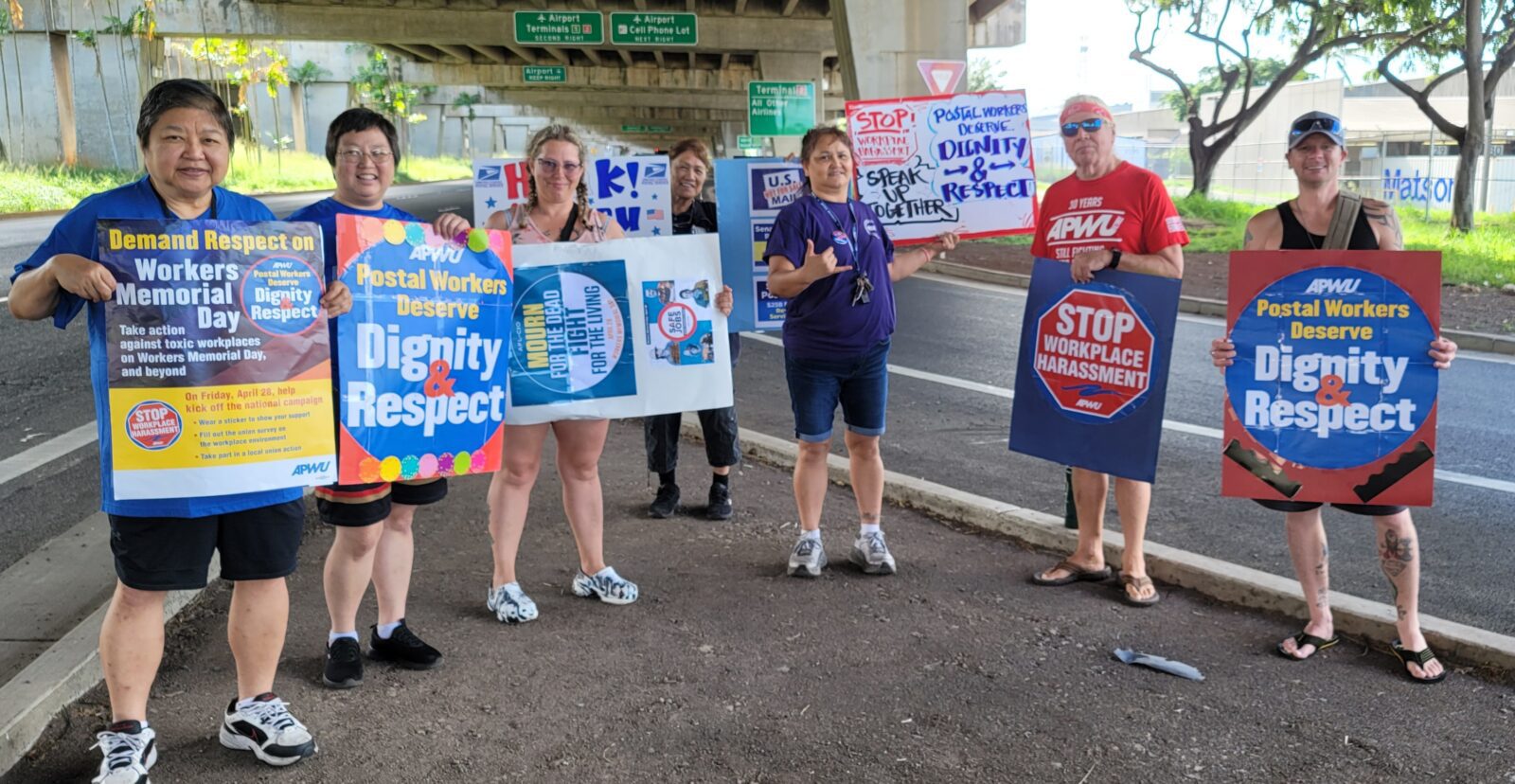 Hawaiian postal workers hold signs for Workers Memorial Day