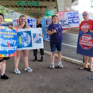 Hawaiian postal workers hold signs for Workers Memorial Day