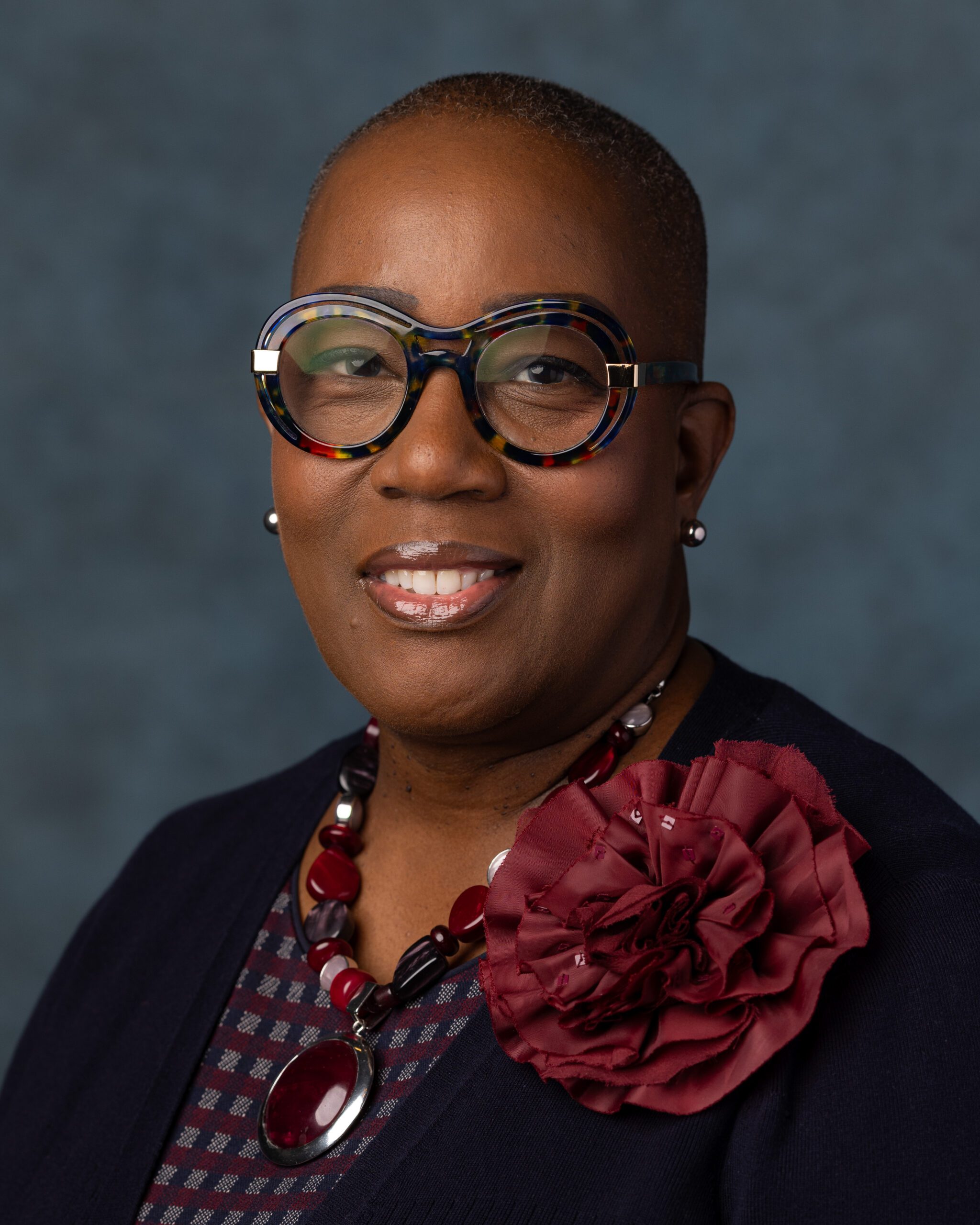 An image of tiffany foster posed for a headshot, smiling at the camera.