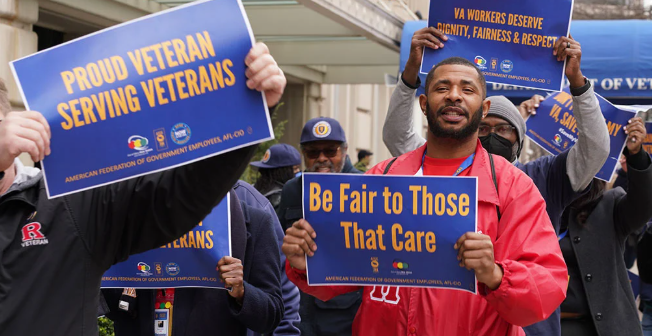 AFGE members rally holding signs taht say Be Fair to Those that Care and Proud Veteran Serving Veterans