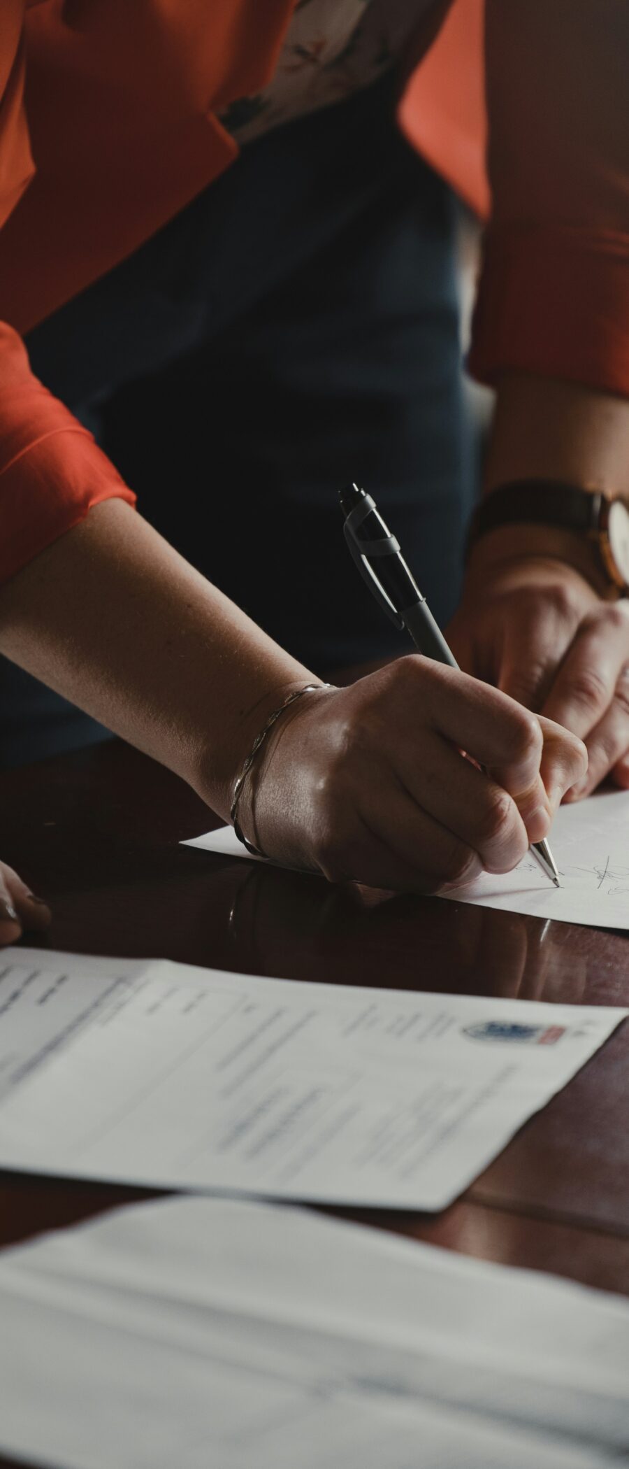 a pair of hands in signing a legal document.